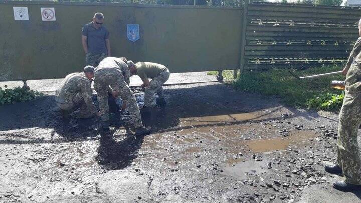 Воины вычерпывали воду из ям на дороге