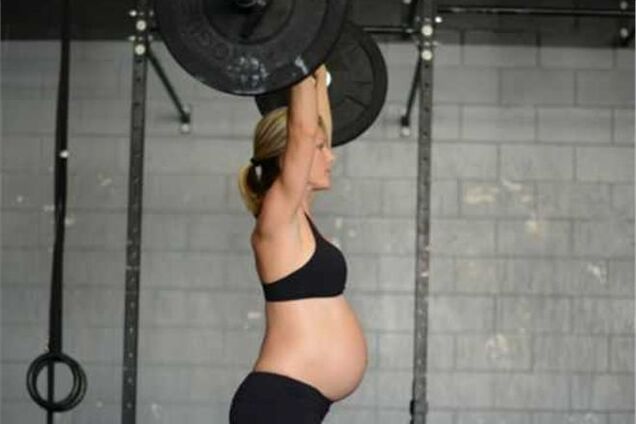 Беременная спортсменка поднимает штангу за две недели до родов