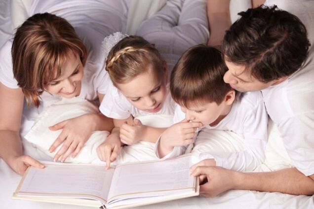родители читают книгу детям