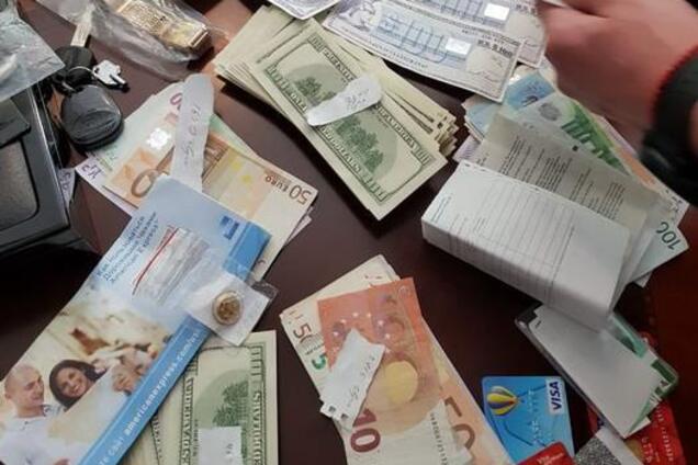 Кучи денег, золото и оружие: в Украине накрыли финансовую пирамиду