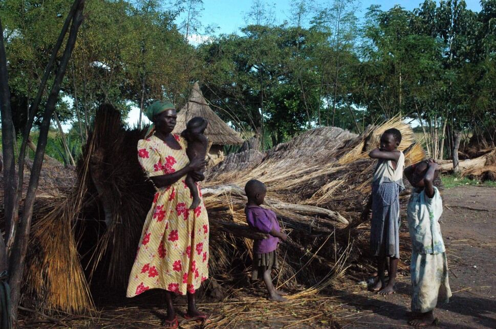 A Ugandan woman stands with some of her