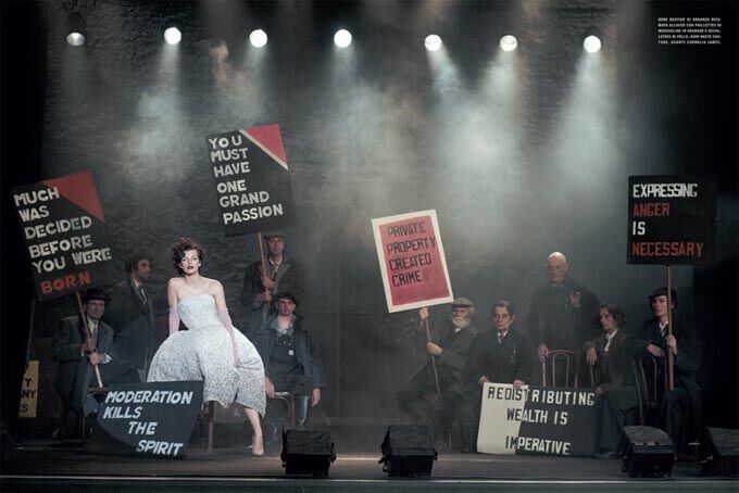 Йовович позирует с транспарантами в руках. Фото