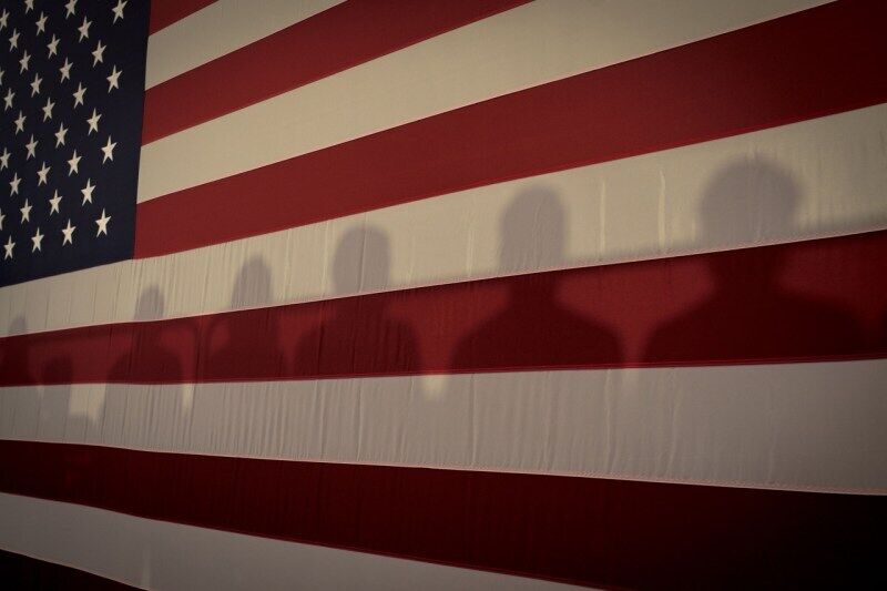 Тени на американском флаге у ратуши с кандидатом в президенты от демократов Камалой Харрис, штат Айова, 19 сентября