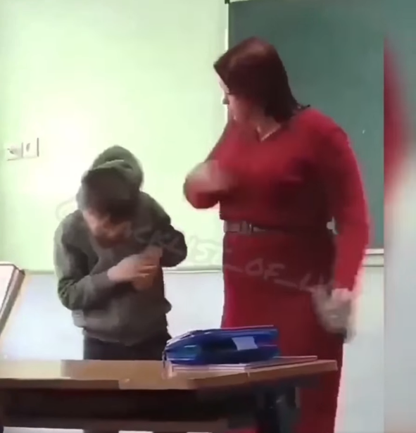 Учительница бьет мальчика по голове