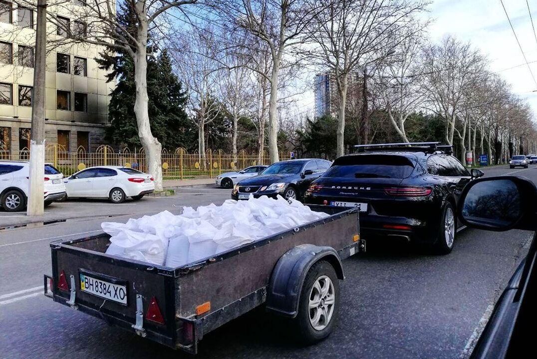 Porsche за 100 000 євро, завантажений причепом з мішками