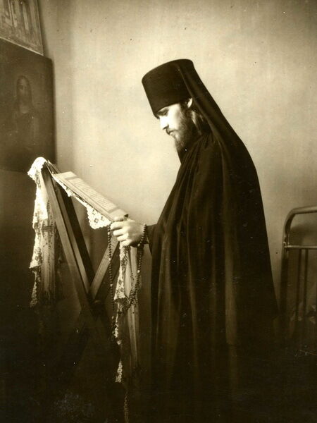 Монах Філарет читає богослужбову літературу
