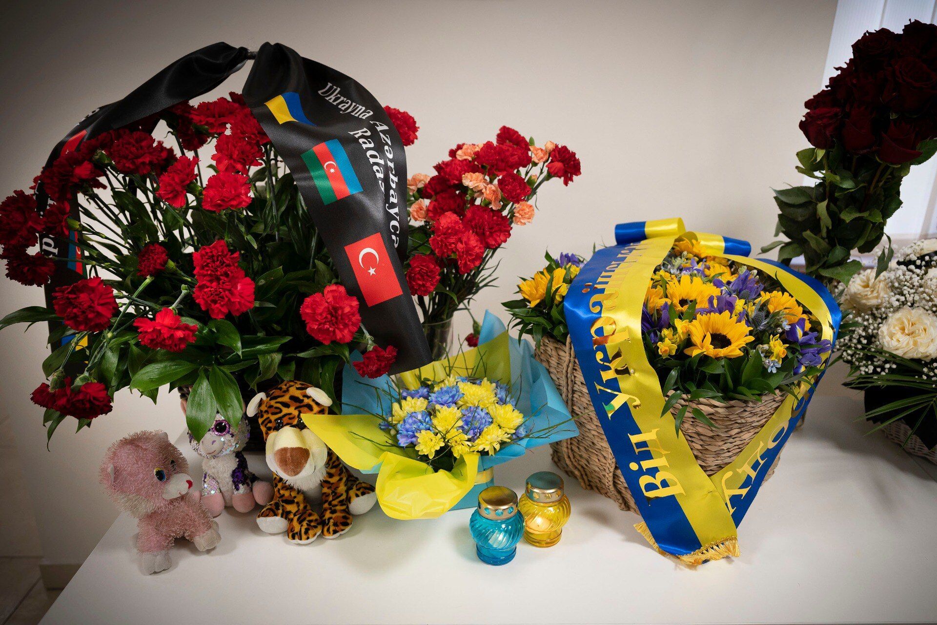 В посольство приносят цветы и игрушки