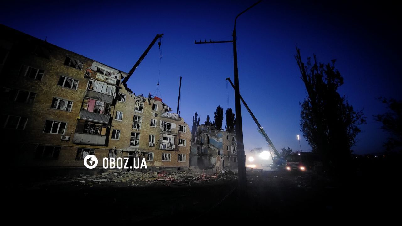 "Не теряют надежды": в Киеве под прожекторами разбирают завалы на месте удара РФ, люди приносят игрушки в память о погибших детях. Фото и видео