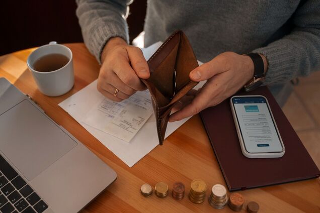 Мужчина держит пустой кошелек. Иллюстрация