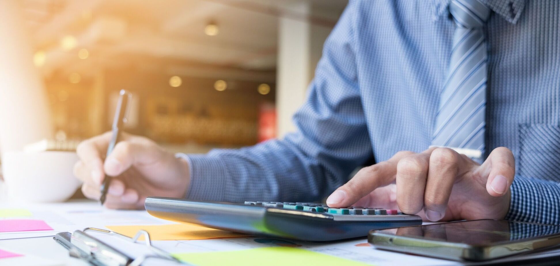 Иллюстрация - мужчина платит налоги, используя калькулятор